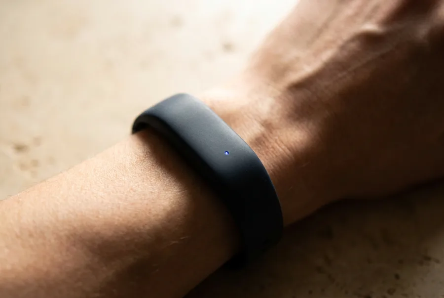 A wearable band on a wrist in warm light